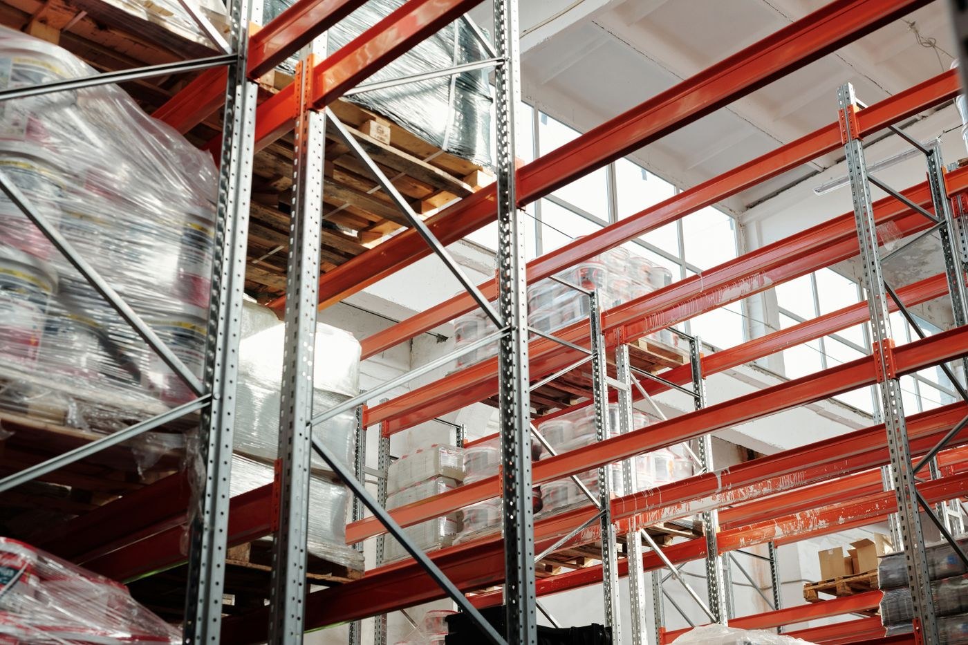 Wrapped palletized goods stored on industrial warehouse racks
